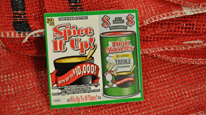 Spice it Up scratch off ticket on a red tartan background
