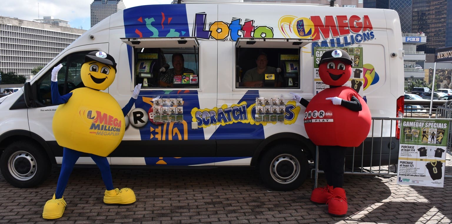 Lottery mascots outside of promotional trailer at event.